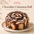 Chocolate cinnamon roll with cream cheese frosting and chocolate drizzle on a plate, branded 'oofy'.